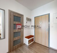 Interior of a 2-room apartment with a wooden decor floor and a mirror on the wall.