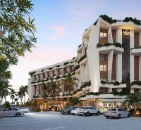 Residential complex in Paje, Unguja South, surrounded by greenery, parking in front of the building.