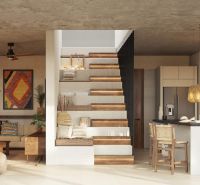 Living room of a two-room apartment with a kitchen, staircase, and plants.