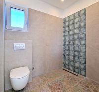 Bathroom in a 3-room apartment with wall tiles and floor with decor.