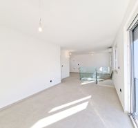 A bright room in a 3-room apartment with white walls and large windows.