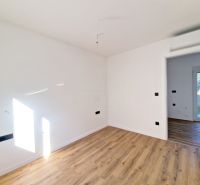 A room in a 3-room apartment with a wooden decor floor, light walls, doors open.