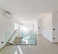 Interior of a 3-room apartment with glass railings and large windows.