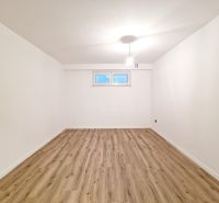 A spacious room in a 3-room apartment with a wooden decor floor.