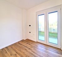 A room in a 3-room apartment with white walls and a wooden decor floor.