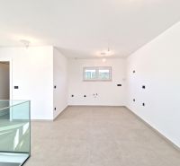 A spacious room in a 3-room apartment with a large window and light-colored walls.