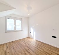 A room with white walls and a floor with a wooden decor in a 3-room apartment.