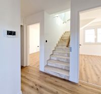 The 3-room apartment has a wooden decor floor and a staircase.