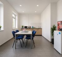 Dining room in warehouses and halls with a kitchenette, table and chairs, bright environment.