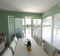 Dining area in a 3-room apartment with a view and seating.