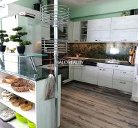 A kitchen with marble tiles, a wooden decor floor and counter, 3-room apartment.