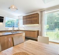 A kitchen in a family house with a kitchen unit and a wooden decor floor.