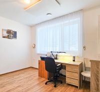 A work corner in a family house with a wooden decor floor and a writing desk.