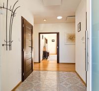 Interior of a family house with decorated floors and modern furniture in the hallway.