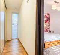 Hallway and bedroom with decorative wall and floor with wood decor in a family house.