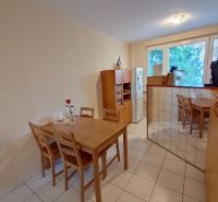 Dining area with a table and chairs in a 2-room apartment.