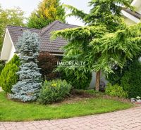 A family house in Žabokreky nad Nitrou with trees and a landscaped garden.