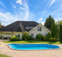 A family house in Žabokreky nad Nitrou with a swimming pool and a garden surrounded by greenery.