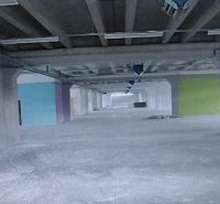 Industrial space with incomplete flooring, colorful walls, and ceilings with construction in warehouses and halls.