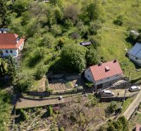 A family house in the village of Banky surrounded by greenery and gardens, in the countryside.