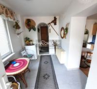 Interior of a family house with a tiled floor, walkway, and decorations.