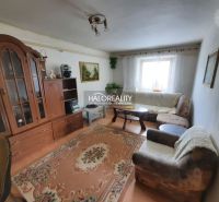 Living room in a family house with sofas, carpet, and furniture.
