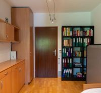 Wooden floor decor, built-in cabinets, and bookshelves in a 3-room apartment.