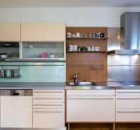 A stylish kitchen with a wooden decor floor in a 3-room apartment.