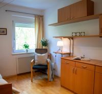 A room in a 3-room apartment with a wooden decor floor and wooden furniture.
