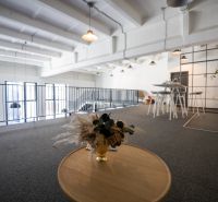 Offices with wood-patterned flooring, light-colored walls, and modern furniture.