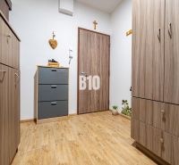 Interior of a one-bedroom apartment with a wooden decor floor and wardrobe closets.