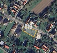 Aerial view of a residential plot in Moravské Lieskové with visible street and buildings.