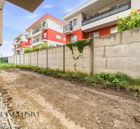 A garden at a 3-room apartment in Senec on Dlha Street, with a view of the apartment buildings.