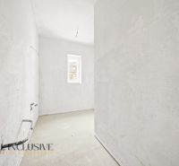 An unfurnished kitchen in a 3-room apartment with a concrete floor and a small window.
