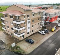Apartment building in Senec on Dlhá Street with parked cars and surroundings.