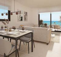 Interior of a 2-room apartment with a dining table, sofa, and sea view.