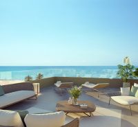 Terrace of a 2-bedroom apartment in El Puig with a sea view, rattan furniture.