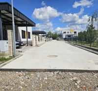 Houses on Rozbehov Street, Varín, Residential plots, next to a concrete walkway with a garden.