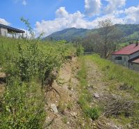 Plots - living in Rozbehov, Varín with a view of the mountainous landscape and a house with a gabled roof.