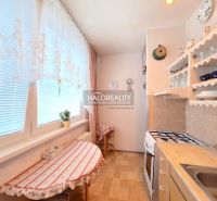 A kitchen in a 2-room apartment with wooden decor and cozy furnishings.