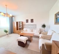 Living room with a sofa and armchairs in a two-room apartment, light furnishings and carpets.