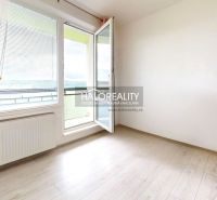 A room of a 2-room apartment with open doors and a floor with a wooden decor.