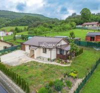 A family house in Dohňany with a pleasant garden, surrounded by greenery and hills in the background.