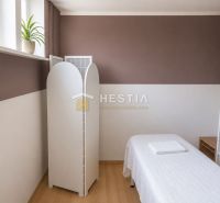 Wellness room in commercial premises with a massage table and wooden floor decor.