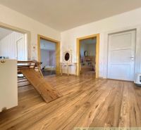 Interior of a family house with a wooden decor floor and wooden door frames.