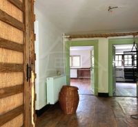 Interior of a family house with a wooden decor floor and a wicker basket in the hallway.
