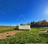 A garden in Nové Hony with a greenhouse by a family house on a sunny plot.