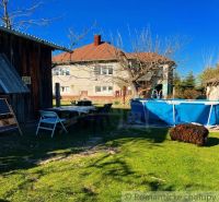 The courtyard of a family house in Nové Hony with a swimming pool and garden seating.