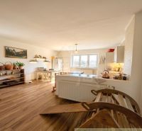 A kitchen in a family house with wooden decor, where light decorations dominate.