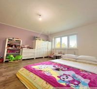 Children's room in a family house with a bed and a wooden decor floor.